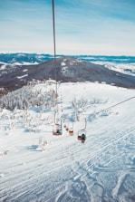 people riding in cable cart on winter season