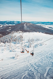 people riding in cable cart on winter season