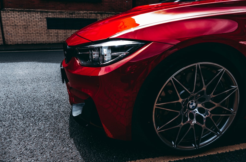 photo of red car on road during daytime