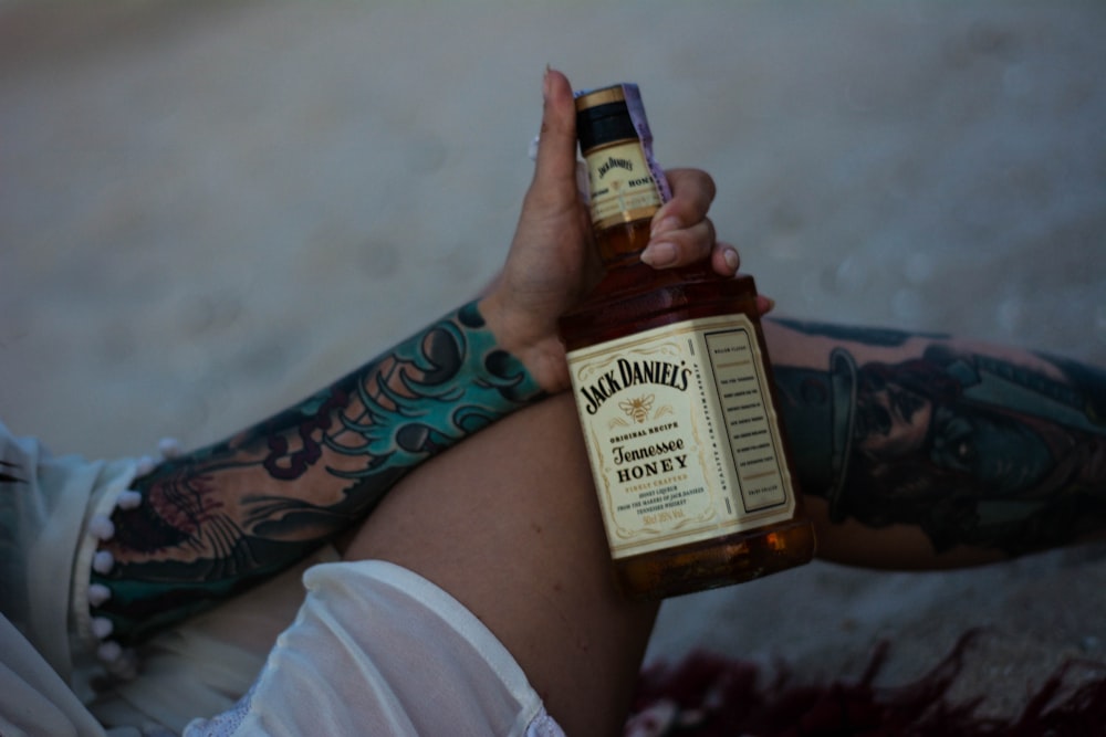 person holding Jack Daniel's whisky bottle