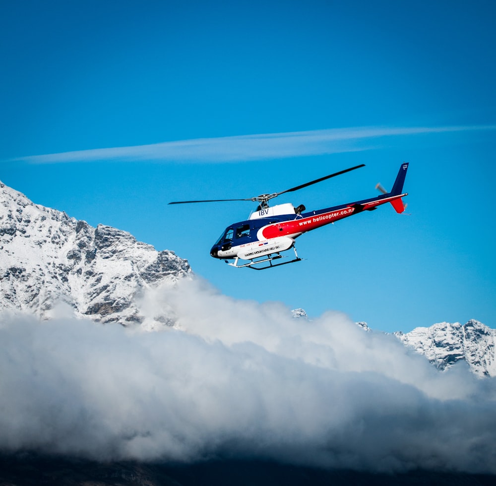 a helicopter flying over a mountain in the sky