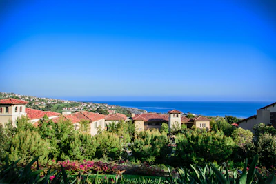 A scenic view of a beautiful Mediterranean coastline with luxury homes.
