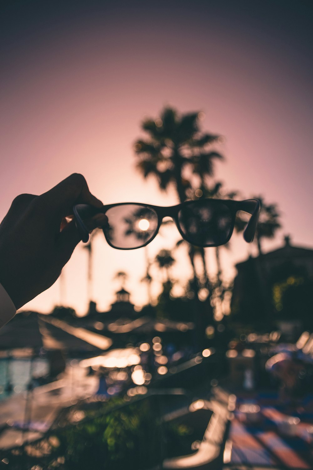 person holding black framed sunglasses