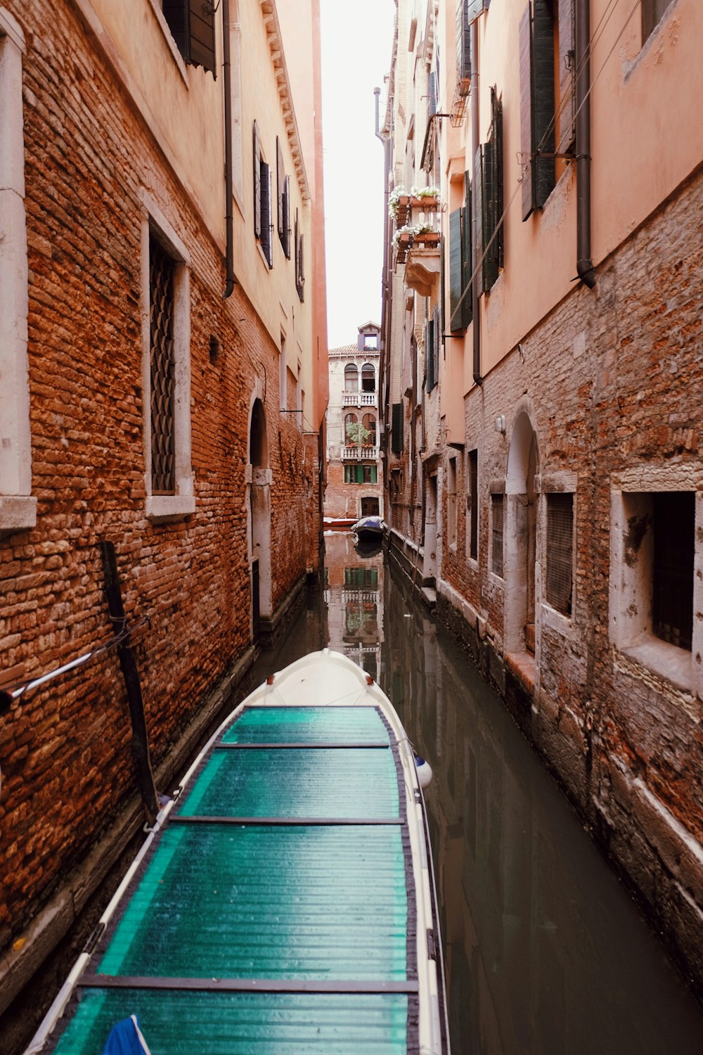 wooden boat between of concrete building