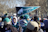 A happy group of sports fans cheering outside a Philadelphia stadium during a sunny day tour.