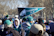 A happy group of sports fans cheering outside a Philadelphia stadium during a sunny day tour.