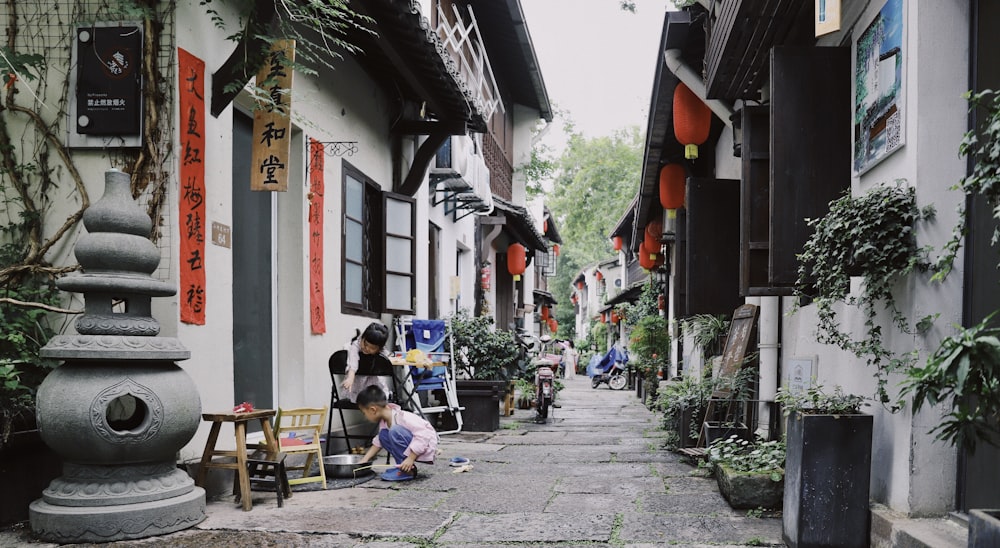 toddler boy playing in front house