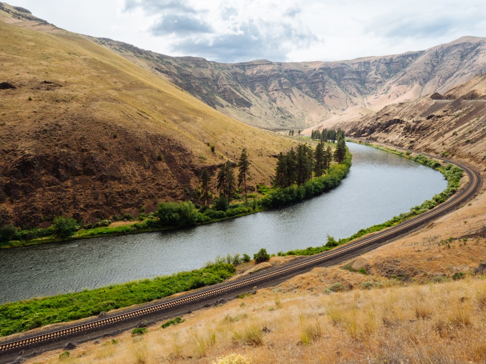 river between brown mountains during daytime