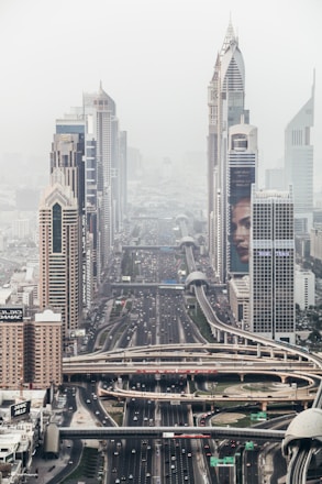 high-rise building with long winding road