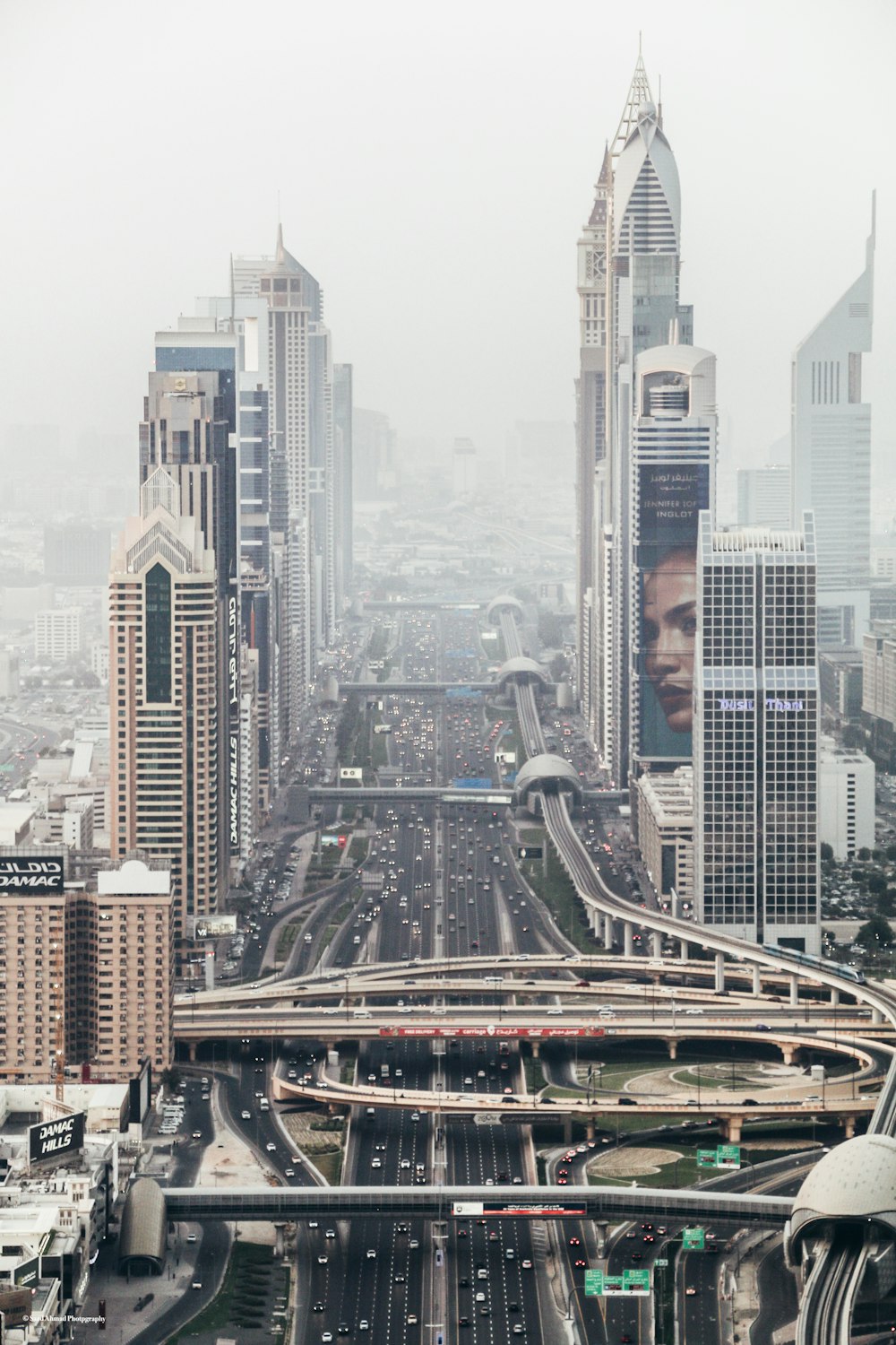 high-rise building with long winding road