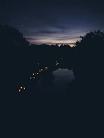 A serene travel scene at dusk with a lantern guiding the way along a quiet path.