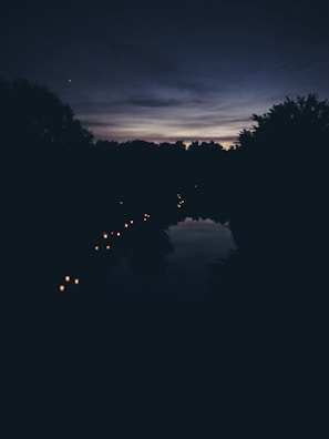 A serene moment of reflection by a glowing lantern at dusk.