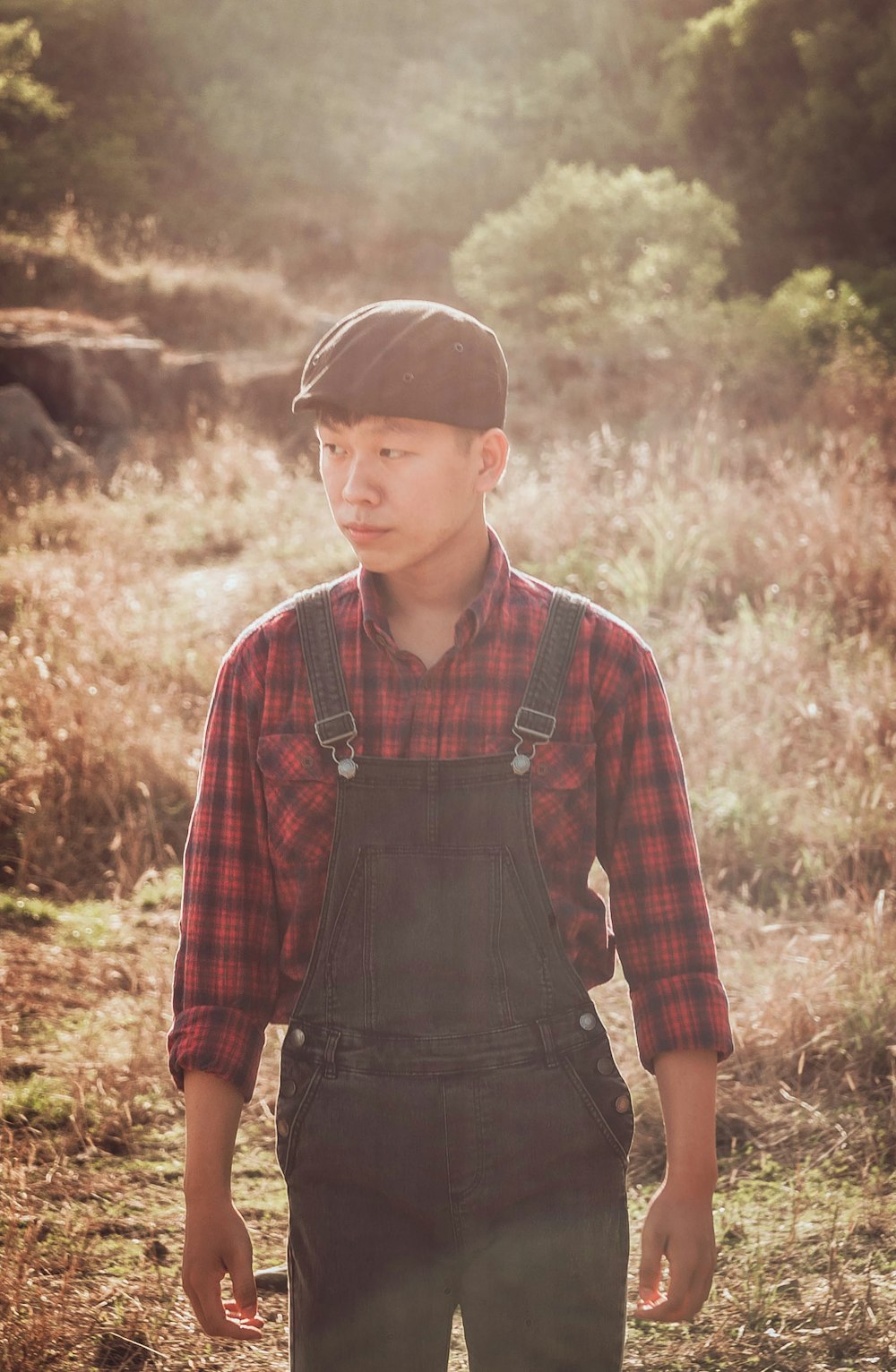 man in black overalls walking on grass