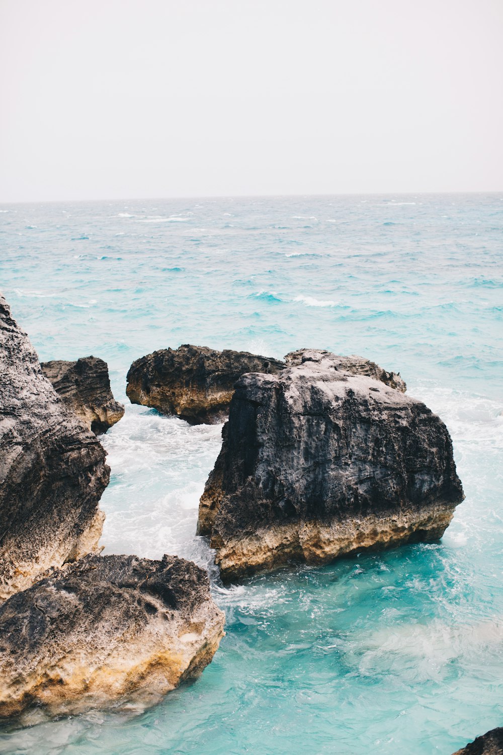 brown stone surrounded with body of water