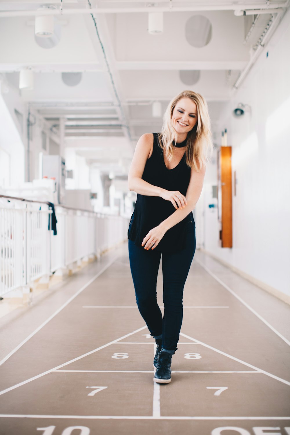 woman playing floor game on corridor