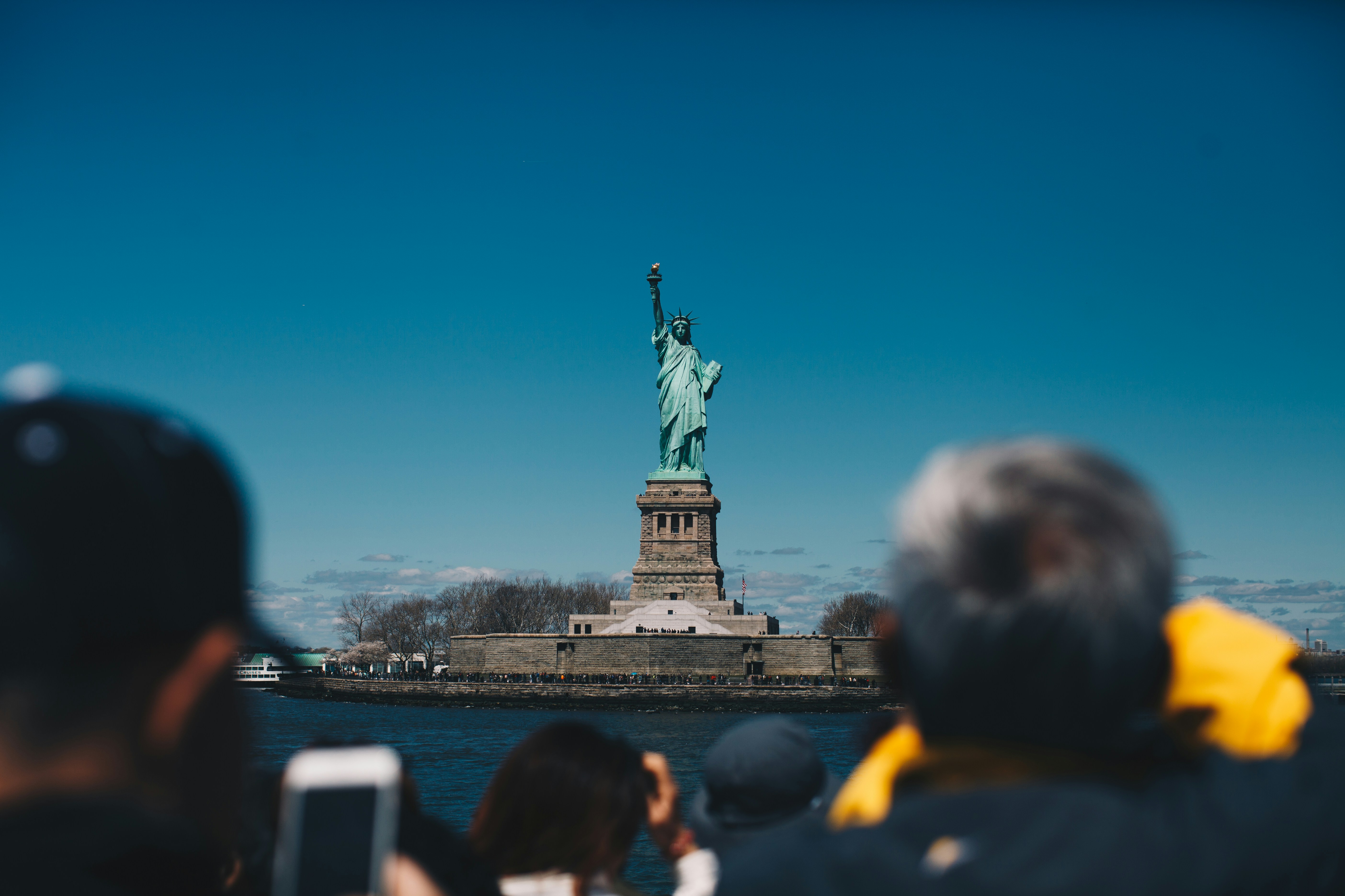 Statue of Liberty with New York Harbor and Manhattan skyline in background