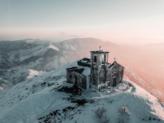 cathedral covered by snow on top of the mountain in Monte Tobbio Italy