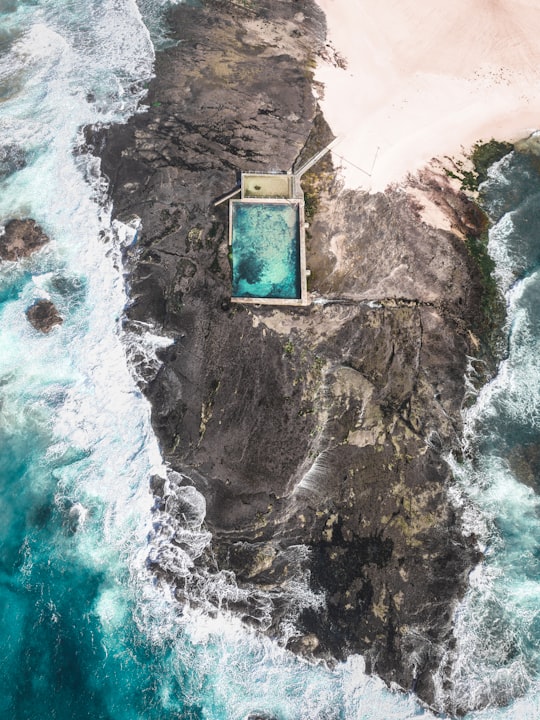aerial photo of building on rock formation in Mona Vale Beach Australia