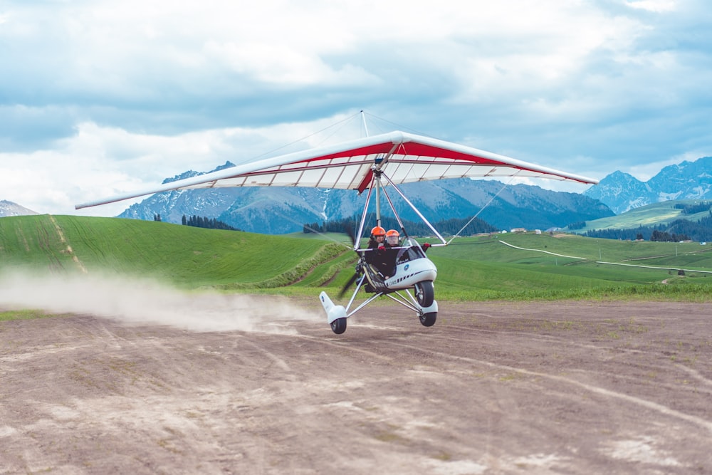 two person riding on paragliding plane