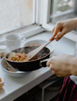 person holding black frying pan
