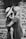 grayscale photography of woman carrying girl