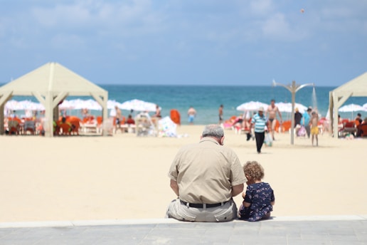 man sitting besides girl on bench
