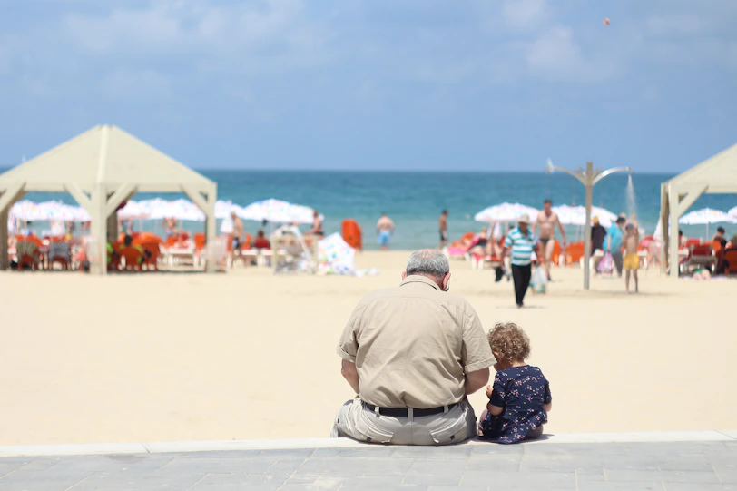 man sitting besides girl on bench
