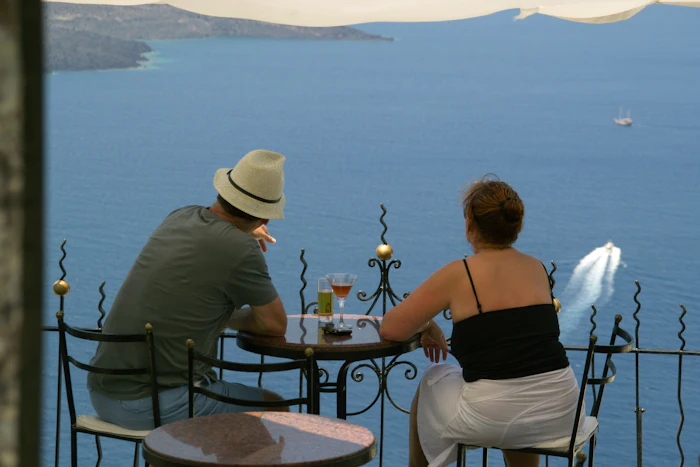 Romantic couple watching the sunset over the Santorini caldera