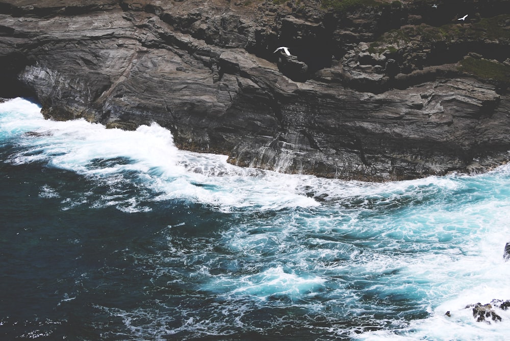 river waves on brown stone