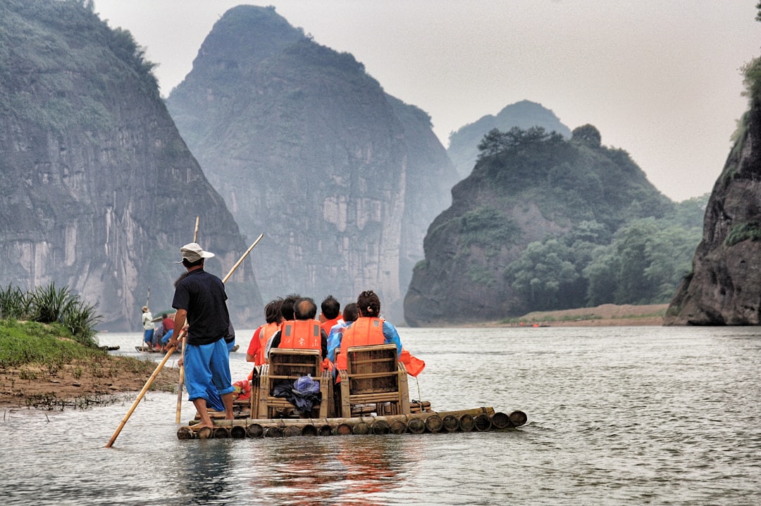 people riding on boat, Dragon river