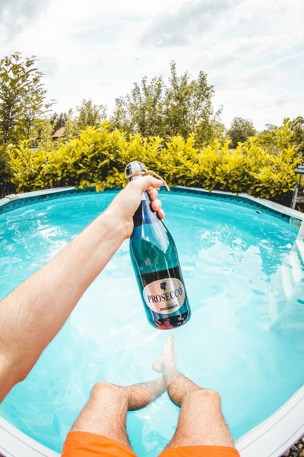 person holding Prosecco bottle