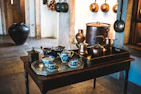 A modern kitchen scene featuring bronze cookware in use, blending tradition with contemporary living.