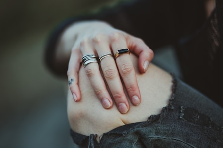 photo of person showing silver-colored ring