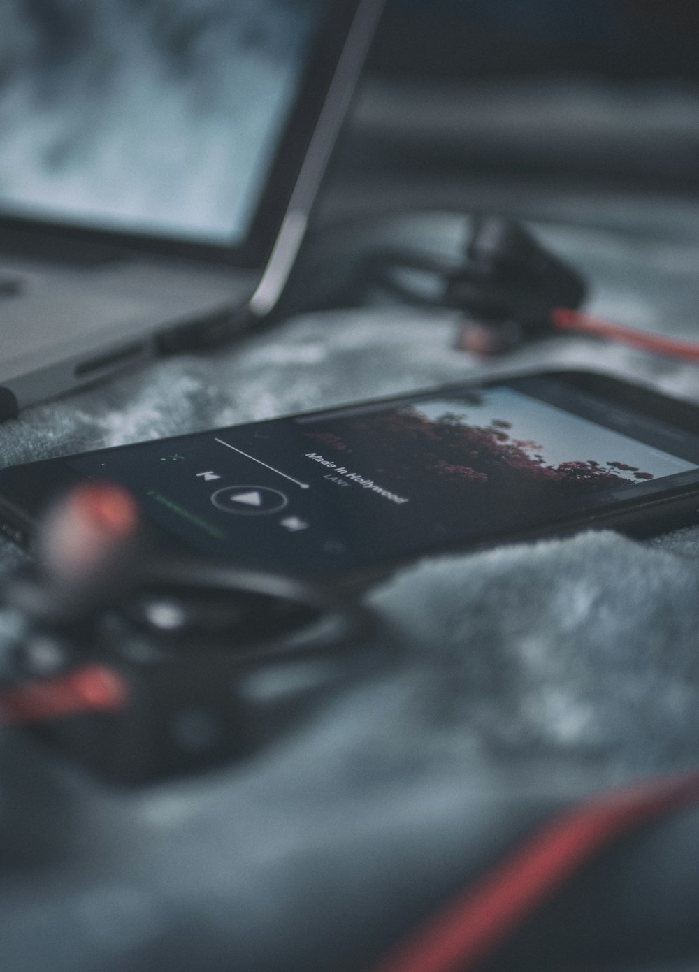 black smartphone on gray textile