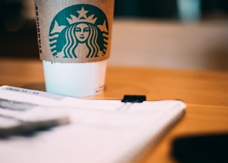 selective focus photography of Starbucks coffee cup