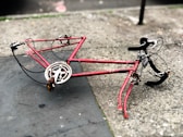red and black road bike on ground
