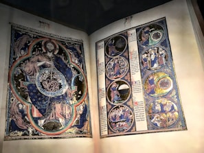 Close-up of a finely detailed replica of an ancient illuminated manuscript page with gold leaf accents.