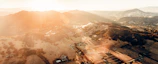 Aerial view of a freshly parceled land plot under golden sunlight.