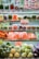A supermarket shelf displays an array of fresh vegetables neatly organized in clear plastic packaging. The shelves are filled with vibrant, fresh produce, including carrots, peppers, broccoli, lettuce, cauliflower, and more. A discount sign offers 10% off, drawing attention to the vibrant selection.