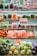 A supermarket shelf displays an array of fresh vegetables neatly organized in clear plastic packaging. The shelves are filled with vibrant, fresh produce, including carrots, peppers, broccoli, lettuce, cauliflower, and more. A discount sign offers 10% off, drawing attention to the vibrant selection.