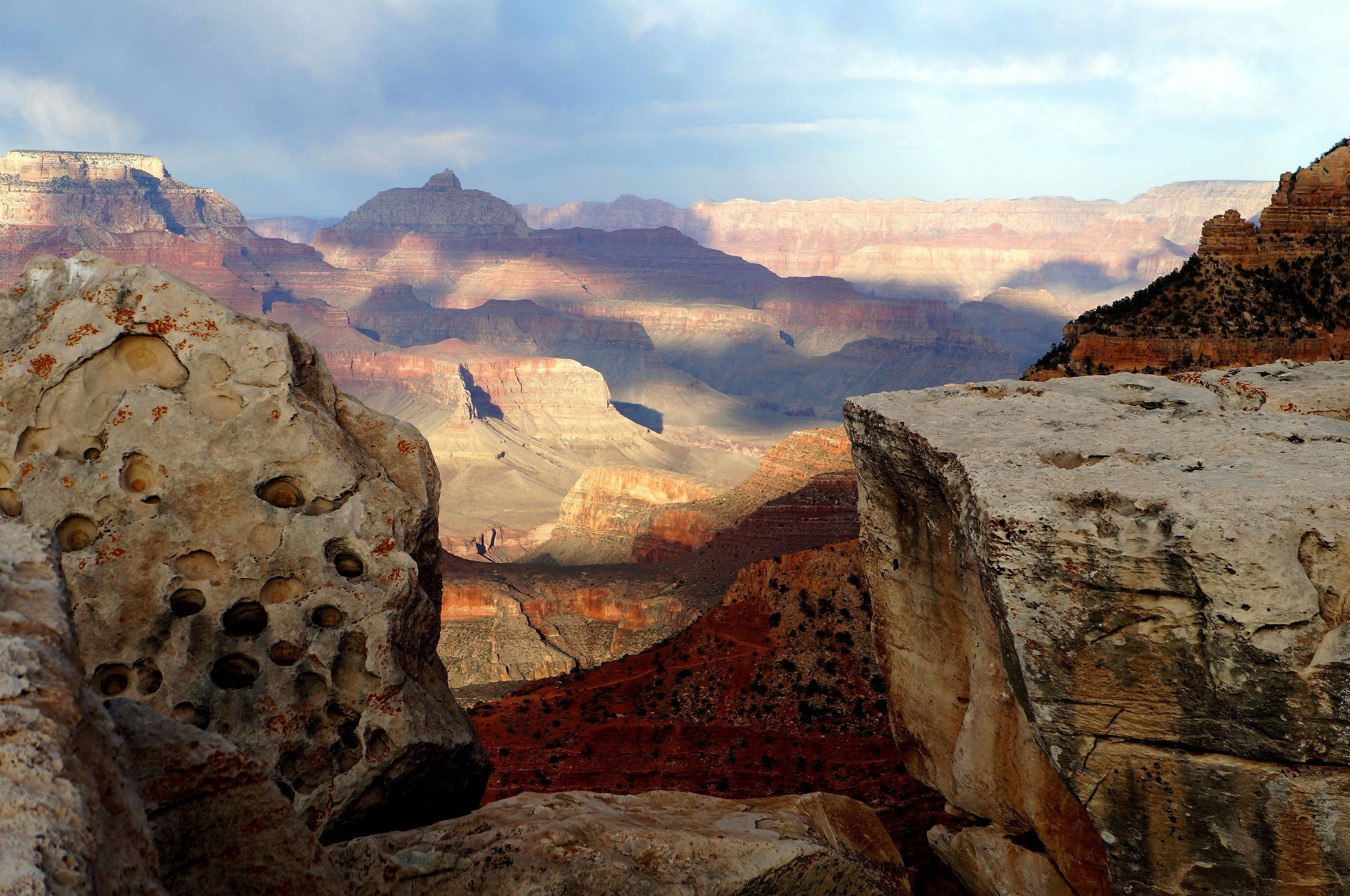 rock mountains under blue sky, Early morning view from the Grand Caynon south rim takes you breath away. For a short moment this canvas of shapes , shadows, & grandeur make me feel timeless......like the caynon itself.