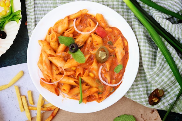 Cooked pasta with sauce and pepper