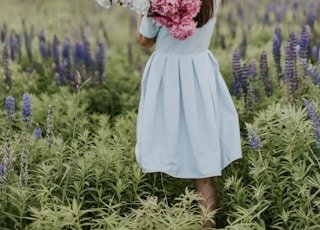 woman carrying pink and white flowers