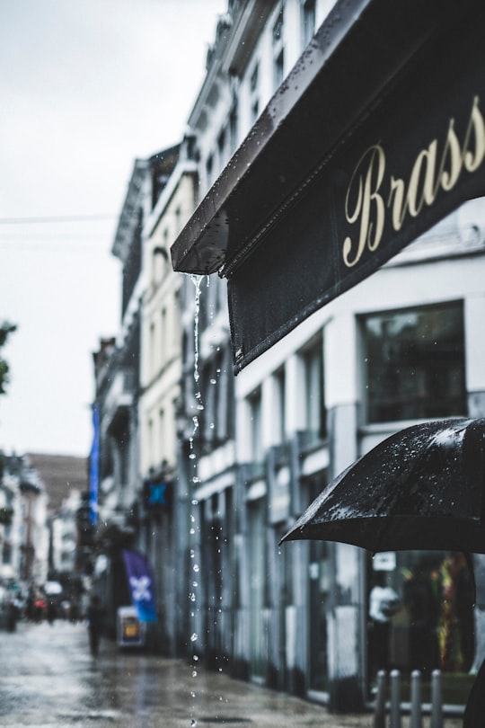 selective focus photography of water droplets from awning in Liège Belgium