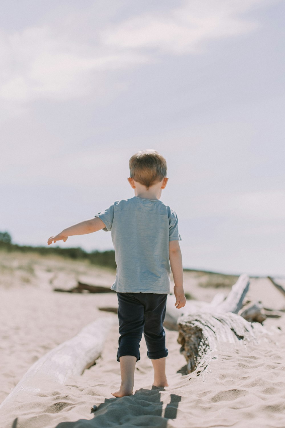 boy standing on sand