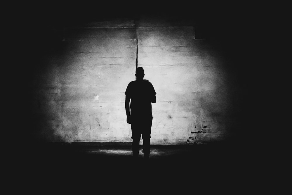 grayscale photography of person standing