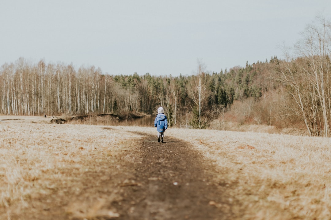 girl standing near trees during daytime