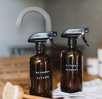 two brown spray bottles on brown table