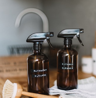 two brown spray bottles on brown table