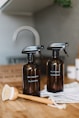 two brown spray bottles on brown table